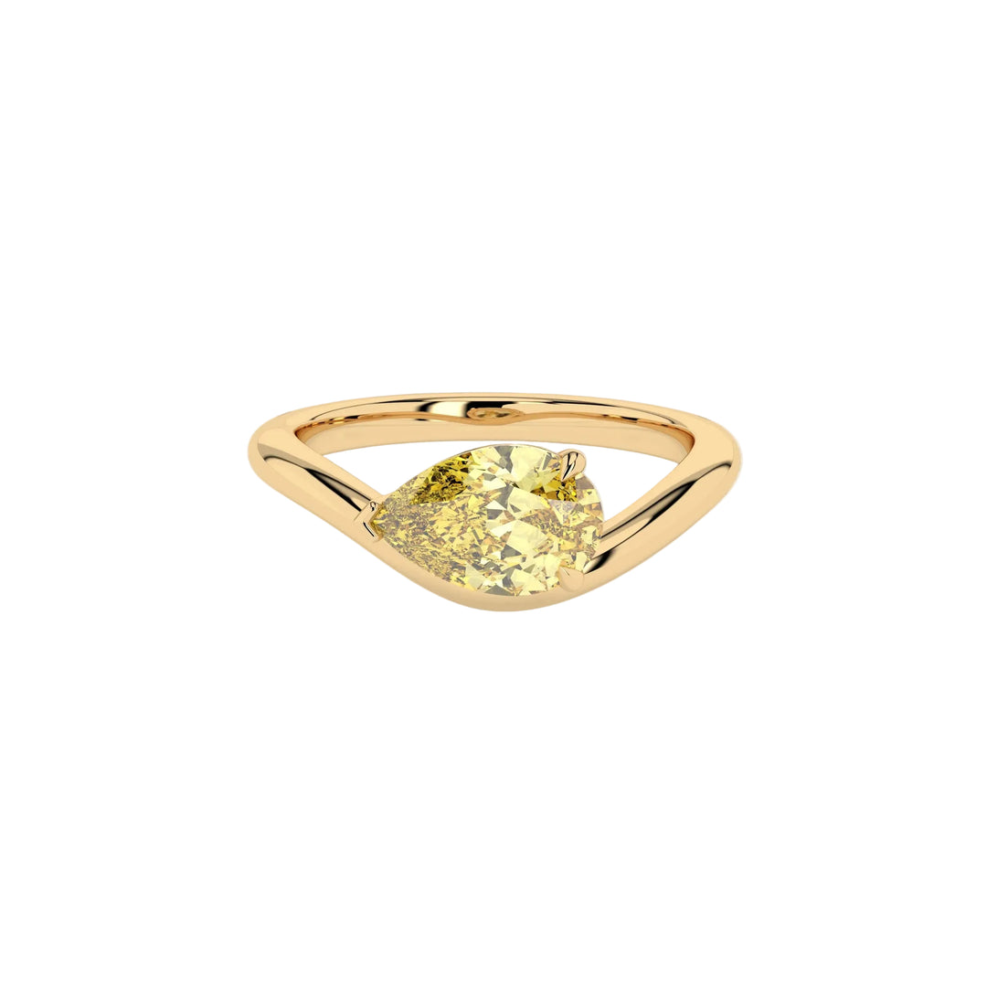 Gold ring with a yellow gemstone on a white background